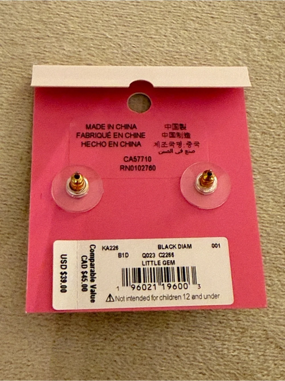 kate spade gold-tone stud earrings with clear backs on pink card
